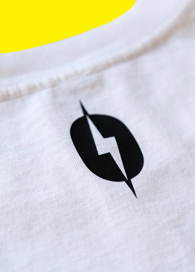 Close-up of the LSR lightning bolt print on the white staple tee